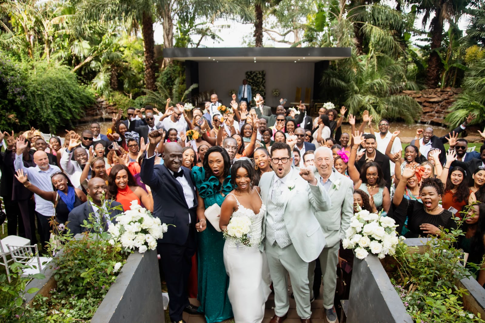 The full wedding party celebrating in the garden