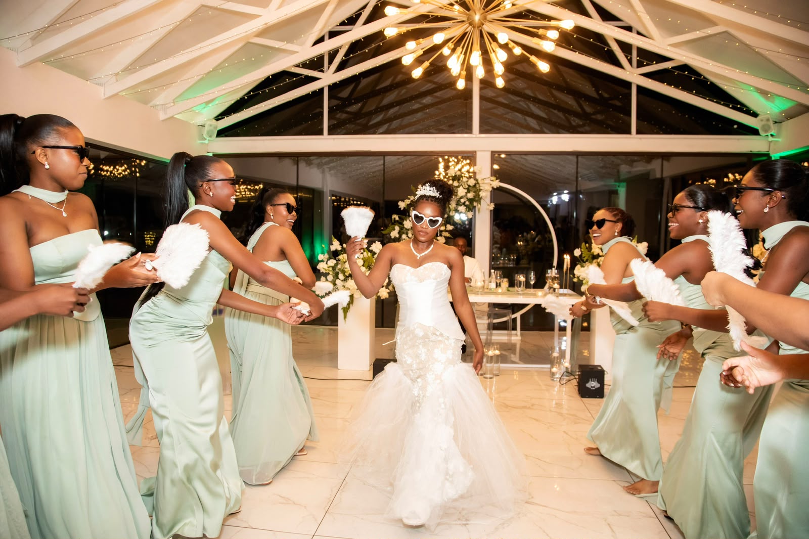 Bride entering the reception with bridesmaids in mint gowns