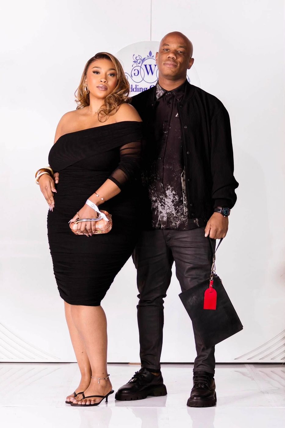 Couple photographed against the event backdrop