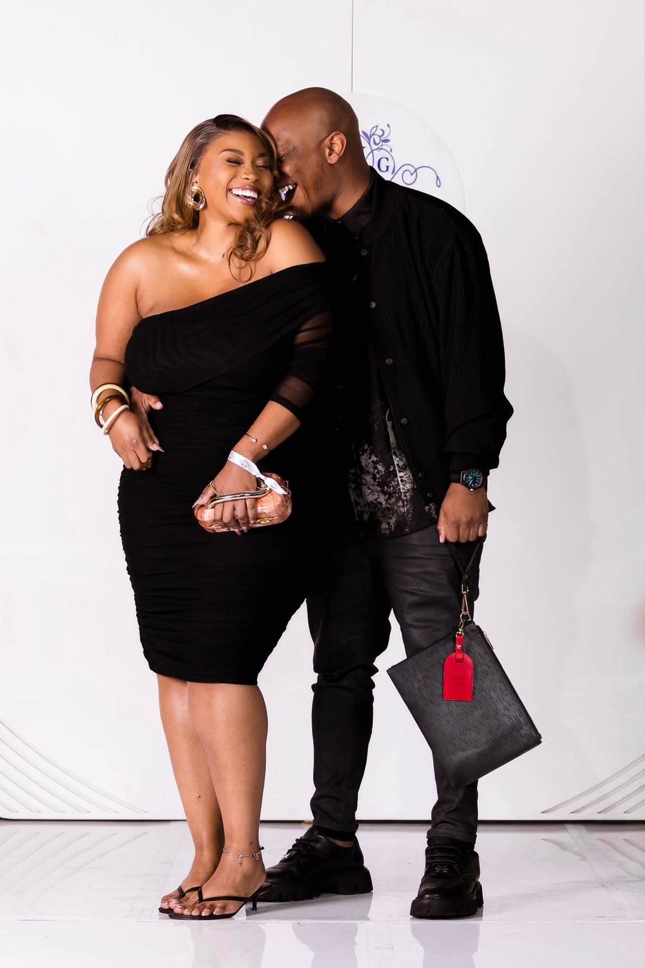 Couple laughing together on the red carpet